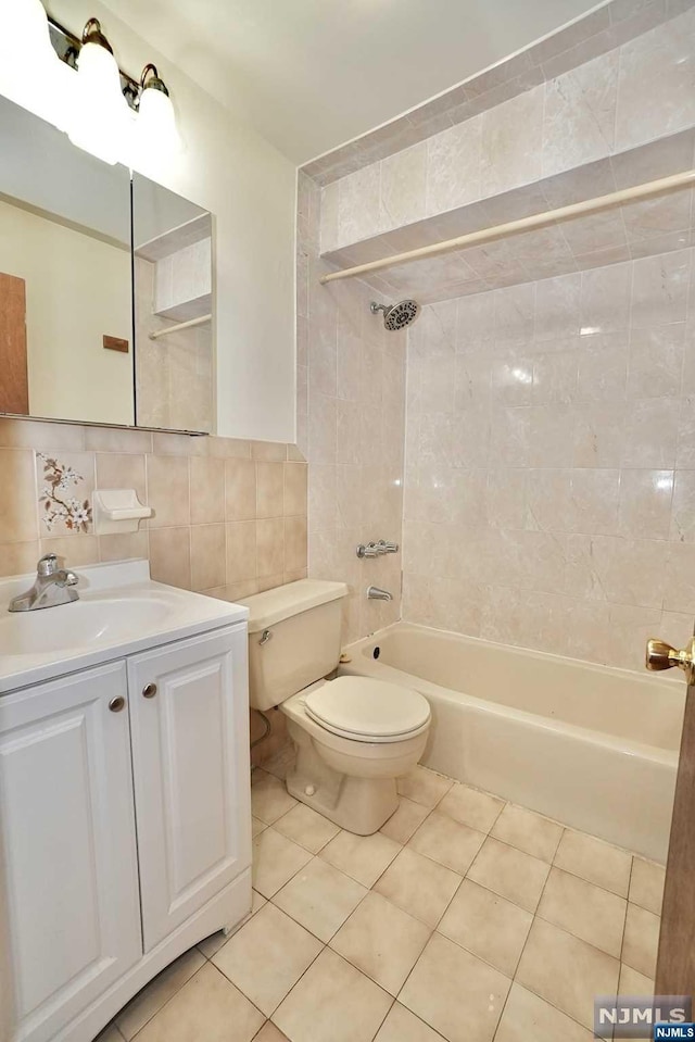 full bathroom featuring tile walls, tasteful backsplash, tiled shower / bath, and tile patterned flooring