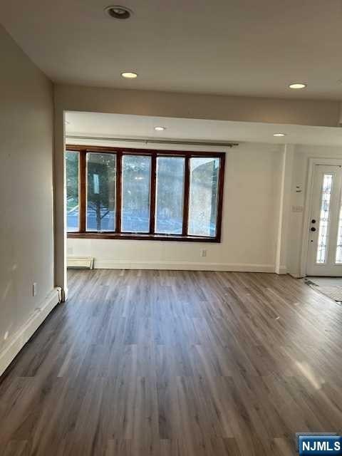 unfurnished living room featuring dark hardwood / wood-style flooring