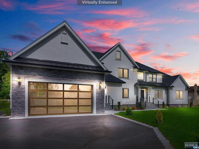 modern farmhouse featuring a lawn and a garage