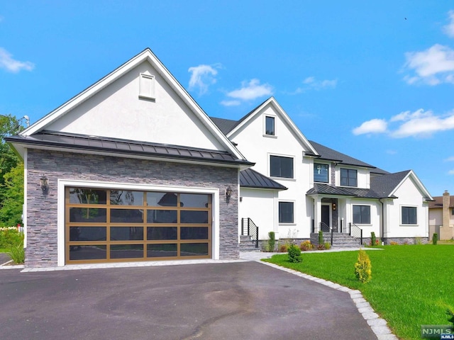 view of front of home with a garage and a front yard