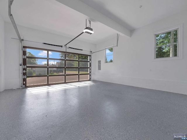 garage with electric panel and a garage door opener