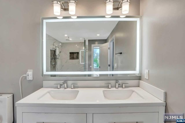 bathroom with vanity and a shower with shower door