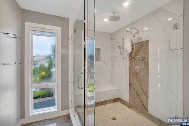 bathroom featuring a shower with door