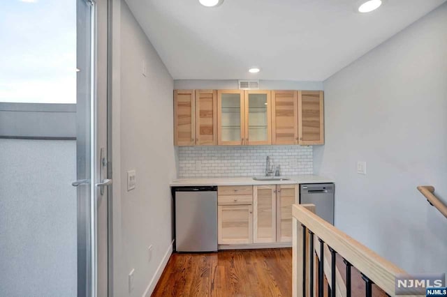 kitchen featuring backsplash, sink, dark wood-type flooring, and light brown cabinets