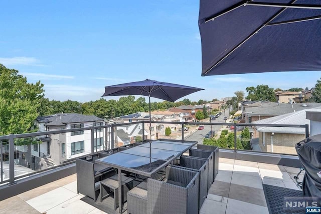 view of patio featuring a balcony