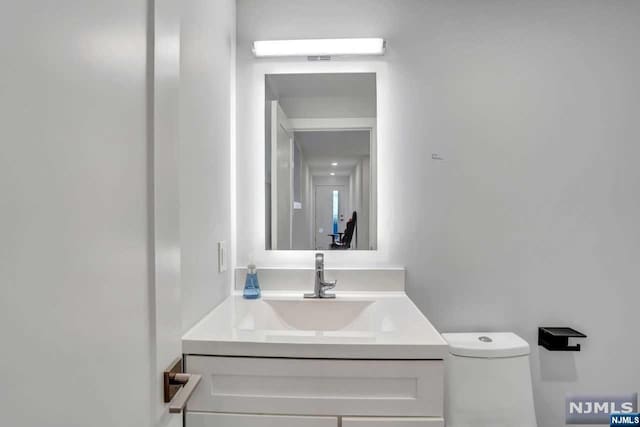 bathroom with vanity and toilet