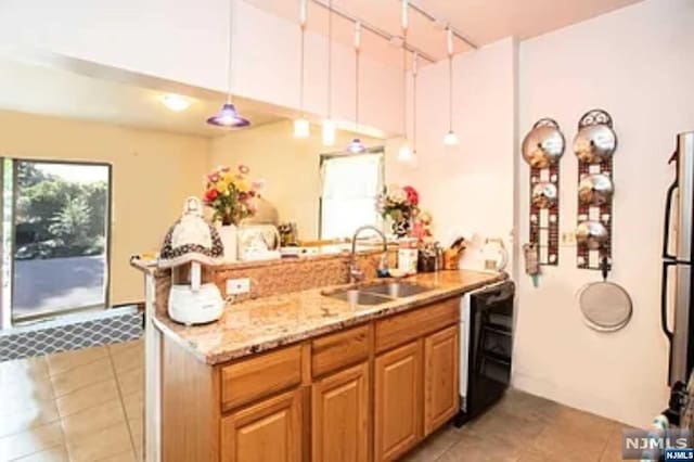 kitchen with kitchen peninsula, sink, pendant lighting, and black dishwasher