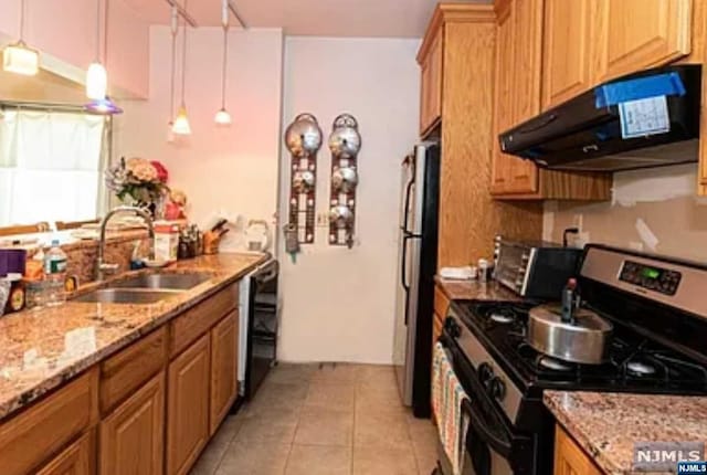 kitchen featuring ventilation hood, stainless steel appliances, sink, light tile patterned floors, and pendant lighting