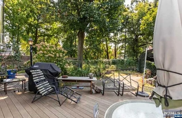 wooden terrace featuring grilling area