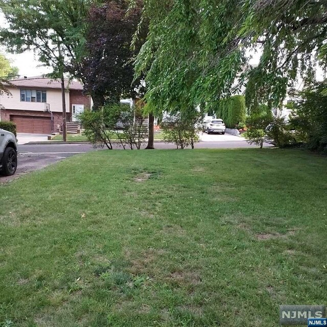 415 Jefferson Ave, Hasbrouck Heights, NJ 07604 - view of yard featuring a garage