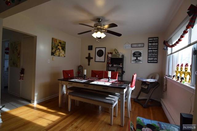 dining room with baseboard heating, ceiling fan, and light hardwood / wood-style flooring