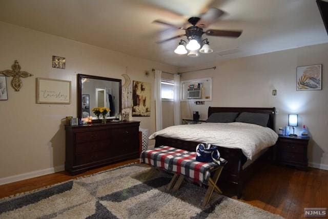 bedroom with dark hardwood / wood-style floors and ceiling fan