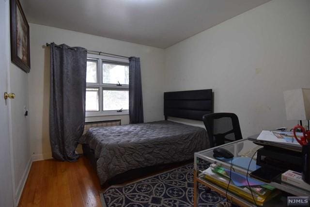 bedroom with wood-type flooring