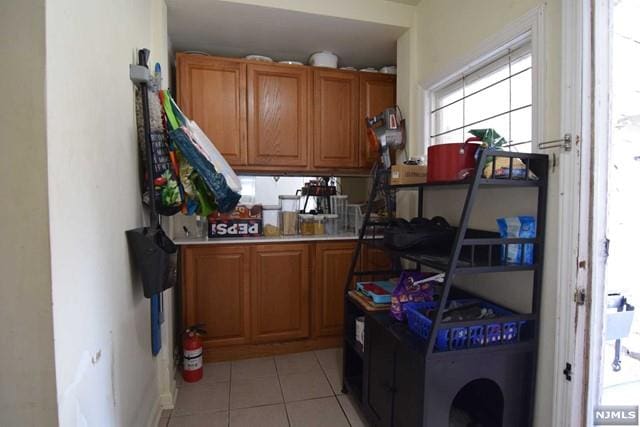 interior space featuring washer / clothes dryer and light tile patterned flooring