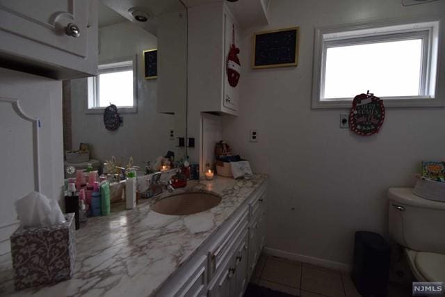 bathroom with tile patterned floors, vanity, and toilet