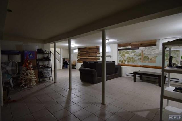 basement featuring plenty of natural light and a wall mounted air conditioner