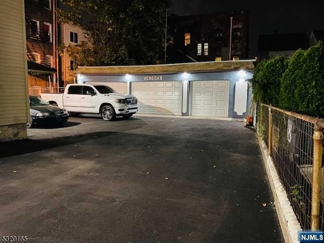 view of garage at twilight