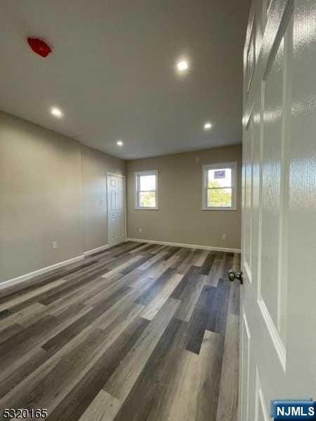 unfurnished room featuring dark hardwood / wood-style floors