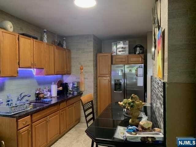 kitchen with stainless steel refrigerator with ice dispenser