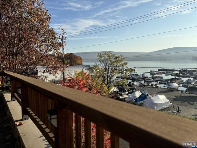 balcony featuring a water and mountain view