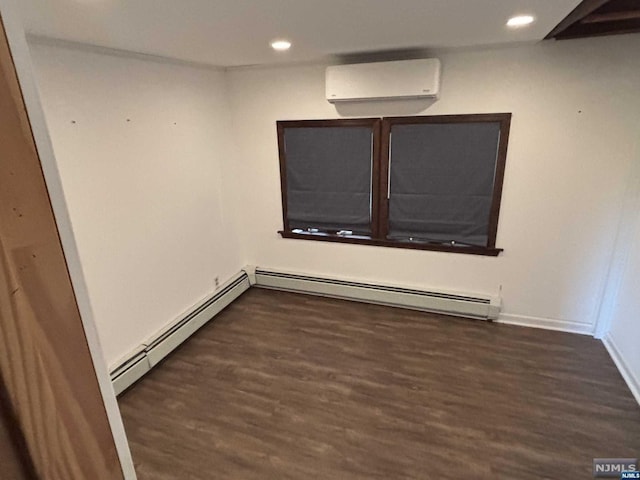 empty room with dark hardwood / wood-style flooring, baseboard heating, and a wall mounted AC