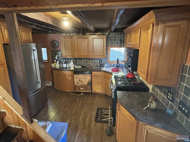 kitchen with beam ceiling, sink, tasteful backsplash, dark hardwood / wood-style floors, and black appliances