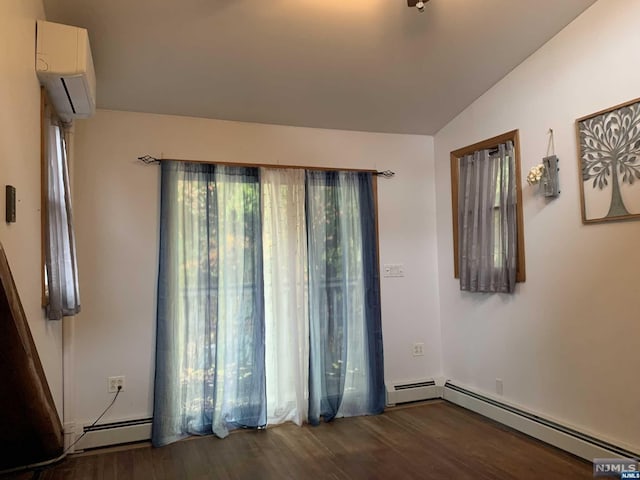 spare room with dark hardwood / wood-style flooring, an AC wall unit, baseboard heating, and vaulted ceiling