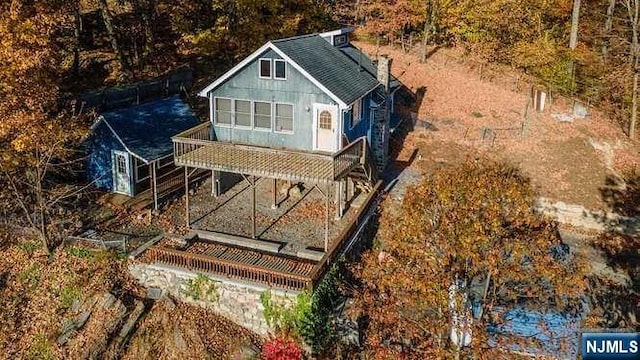 exterior space featuring a balcony and a wooden deck