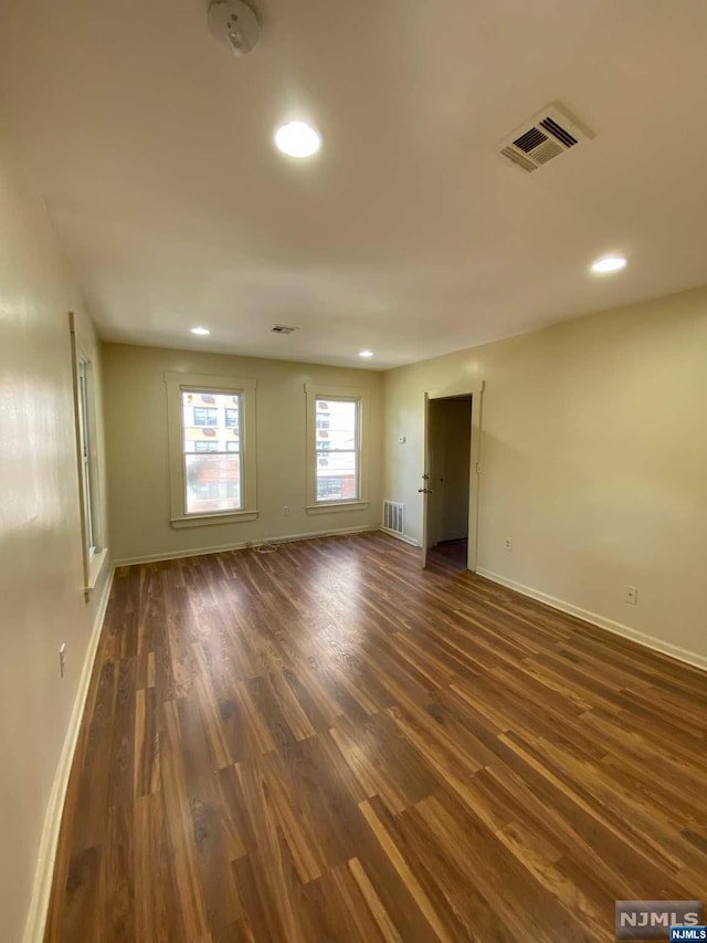 empty room featuring dark wood-type flooring