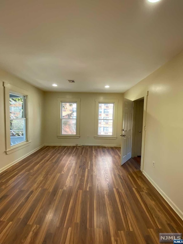 empty room featuring dark wood-type flooring