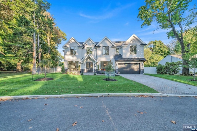 multi unit property with a front lawn and a garage