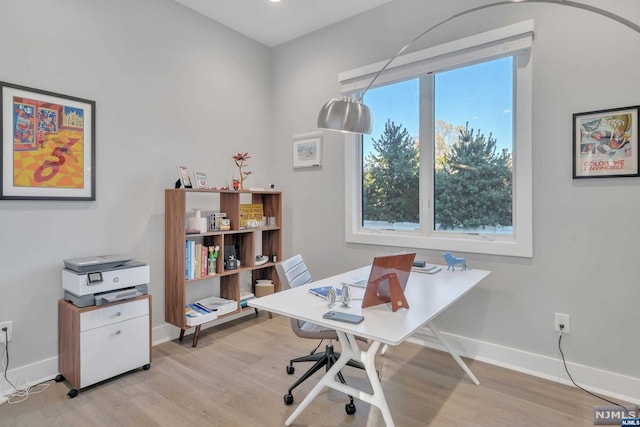 office area with a healthy amount of sunlight and light hardwood / wood-style floors