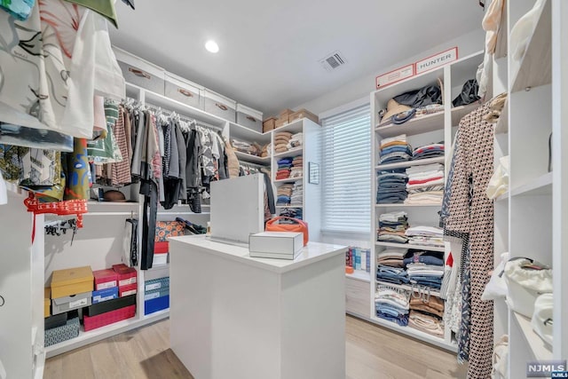 walk in closet featuring light hardwood / wood-style floors