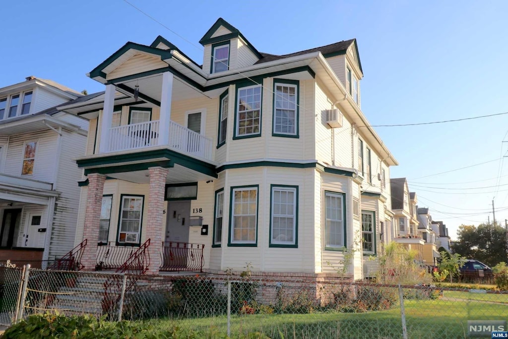 view of front facade featuring covered porch and a balcony