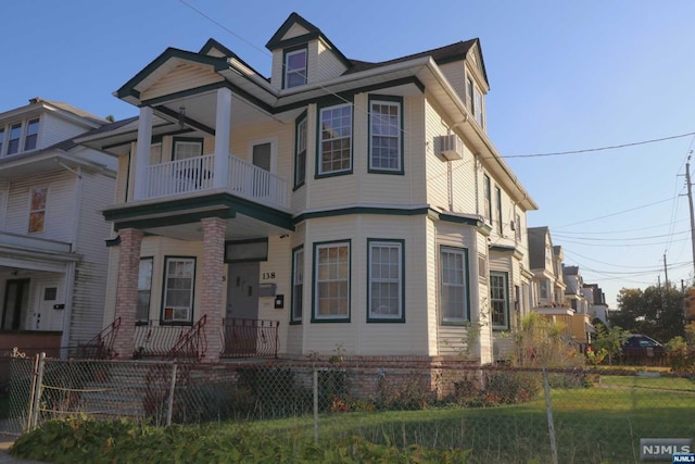 view of front of property with a front yard, a porch, and a balcony