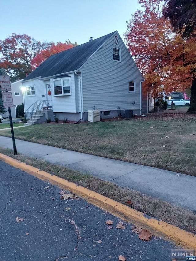 view of home's exterior with a yard and cooling unit