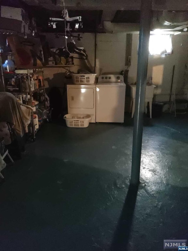 basement featuring washer and clothes dryer and sink