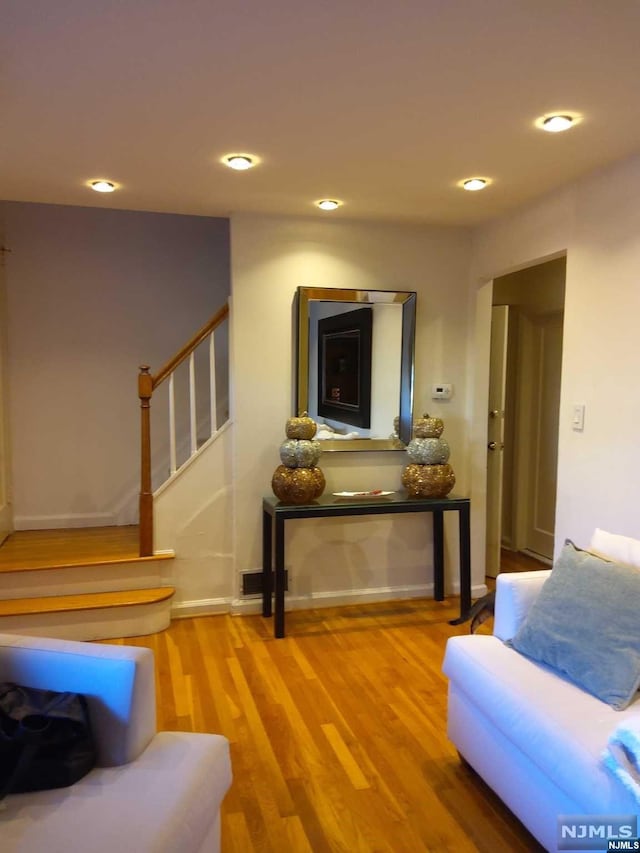 sitting room with hardwood / wood-style flooring