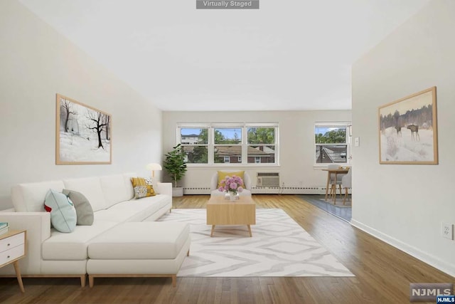 living room with hardwood / wood-style floors and a baseboard heating unit