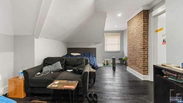 bedroom featuring dark hardwood / wood-style flooring, brick wall, vaulted ceiling, and ornamental molding