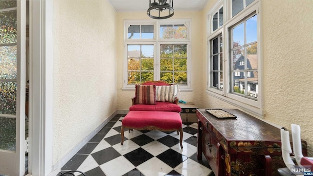 sunroom / solarium with plenty of natural light and a notable chandelier