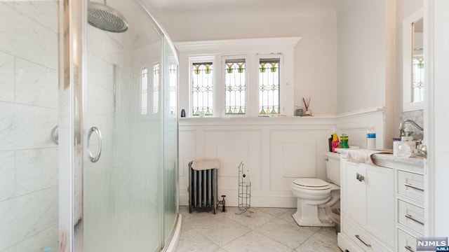 bathroom featuring tile patterned floors, vanity, toilet, and walk in shower