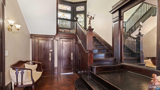 staircase featuring parquet flooring