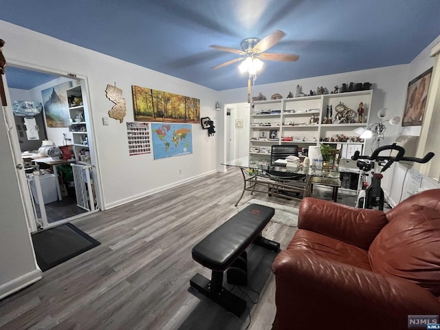 living room featuring ceiling fan and hardwood / wood-style floors