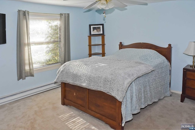 carpeted bedroom with ceiling fan and a baseboard radiator