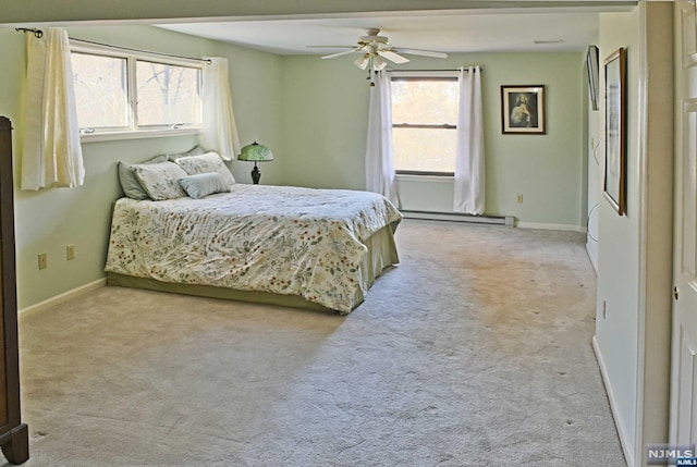 bedroom with baseboard heating, ceiling fan, and light carpet