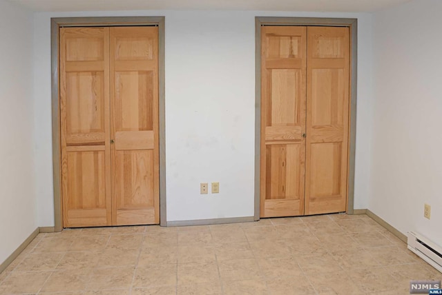 unfurnished bedroom featuring baseboard heating