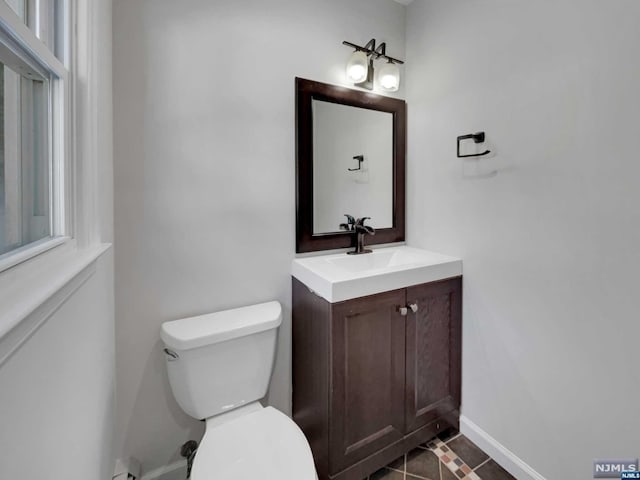 bathroom with tile patterned floors, vanity, and toilet