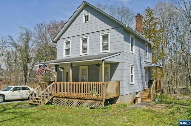 view of front of home with a front yard and a porch