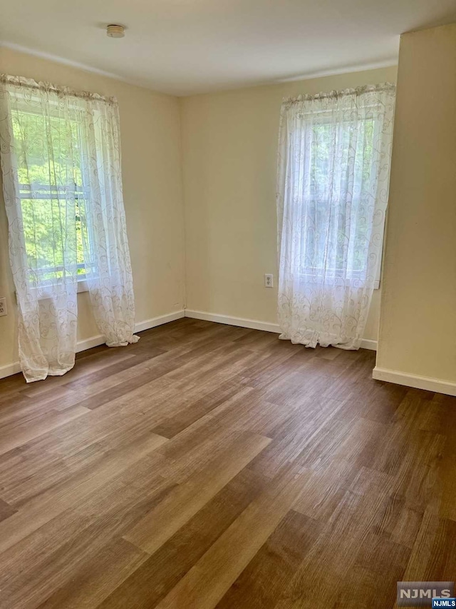 empty room with hardwood / wood-style floors